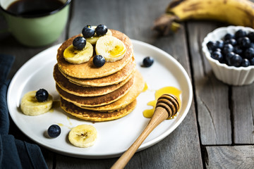 Banana Oat pancakes with honey and blueberries