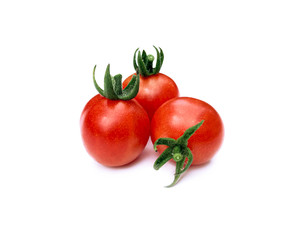 Small and fresh cherry tomatoes on a white background with a sunny shadow. Summer plant. Food product.
