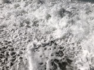 Restless movement of the waves on the sea. Foamy surf. Morning waves in the Mediterranean. In dark colors.