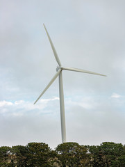 A large wind turbine moving to create kinetic energy for renewable energy supply on a cloudy day located southeast of Lake George and north of Bungendore in New South Wales, Australia 