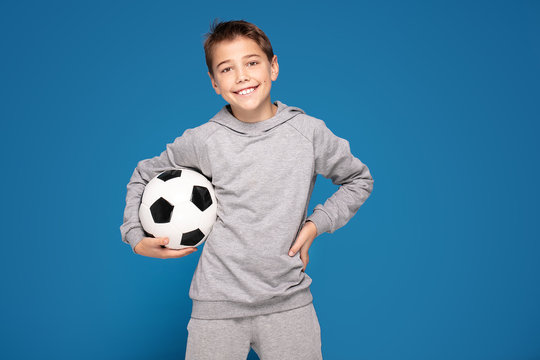 Boy As A Soccer Or Football Player With The Ball .