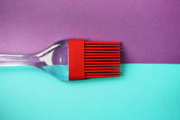 Red Pastry Brush on Vibrant Color Background. Minimal Aesthetics.