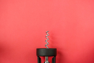Corkscrew on red background. Minimal aesthetics. High resolution photography.