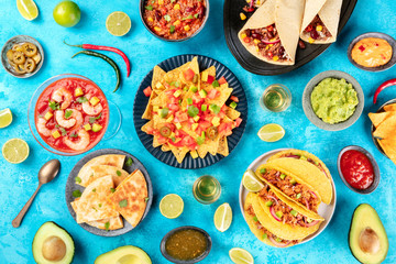 Mexican food, many dishes of the cuisine of Mexico, flat lay, shot from the top on a vibrant blue...