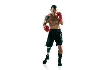 Fototapeta na wymiar Full length portrait of muscular sportsman with prosthetic leg, copy space. Male boxer in red gloves. Isolated shot on white studio background.