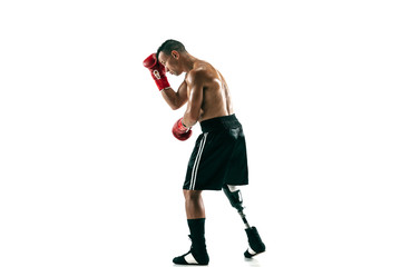Full length portrait of muscular sportsman with prosthetic leg, copy space. Male boxer in red gloves. Isolated shot on white studio background.