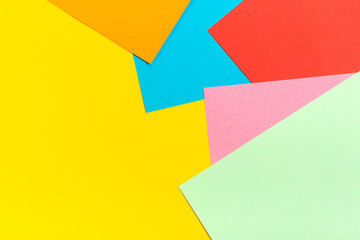 abstract geometric background of colored paper - yellow, red, blue, orange, lilac colors Flat lay Top view Mock up