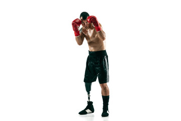 Full length portrait of muscular sportsman with prosthetic leg, copy space. Male boxer in red gloves. Isolated shot on white studio background.