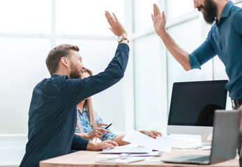 satisfied employees giving each other a high five
