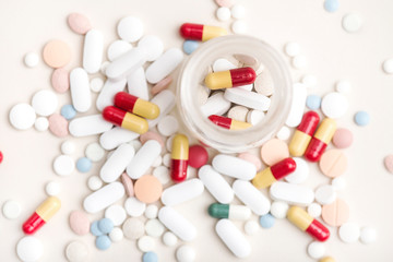 Close up image of pills and tablets in a rustic glass jar