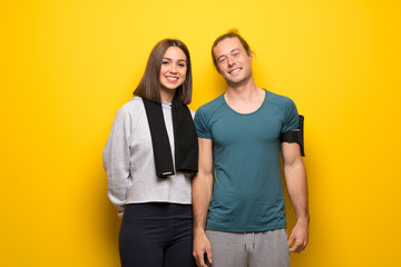 Fototapeta premium Group of athletes over yellow background smiling