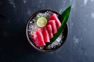 Japanese foods sashimi, Fresh raw sliced fish on black plate, Traditional Japanese food menu