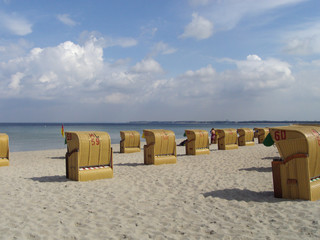 Red roofed chair on sandy beach in Travemunde, North Germany