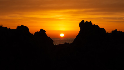 The dawn from the sea, and some rock in fisrt plane.