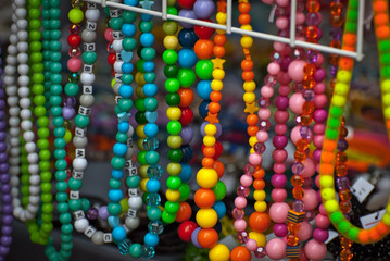 Necklace of colorful stones on the table. Many different jewelry and beads made of natural precious...