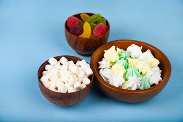 Meringue,marmalade and marshmallow in wooden bowls