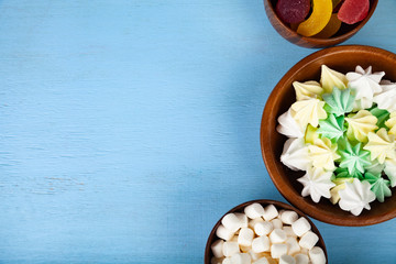 Meringue,marmalade and marshmallow in wooden bowls
