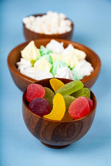 Meringue,marmalade and marshmallow in wooden bowls
