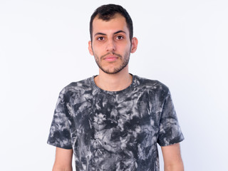 Face of young bearded Persian man looking at camera