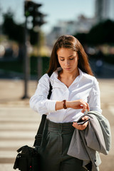 Young businesswoman looking what time is it