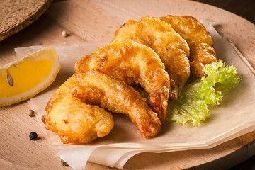 Deep Fried Shrimps on wooden board and baking paper
