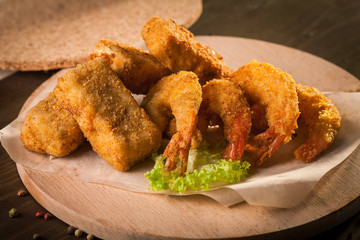 Deep Fried Shrimps on wooden board and baking paper