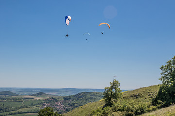 Fototapeta na wymiar Paragliders above south moravia, Pálava, czech republic