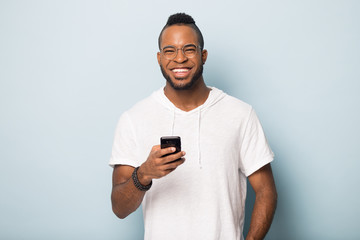 Overjoyed african American male client using modern cellphone