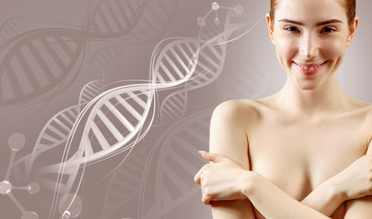 Young woman covering breast by hands among DNA stems.