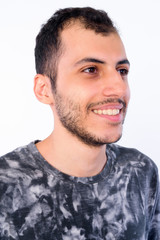 Fototapeta premium Face of happy young bearded Persian man thinking and looking away