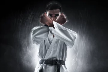 Foto op Canvas Karate martial arts fighter on dark background © fotokitas