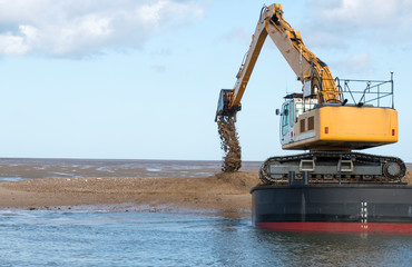 Dredger dumping sand on a bank