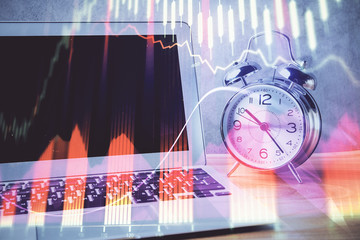 Forex market chart hologram and personal computer background. Double exposure. Concept of investment.