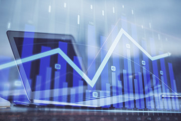Forex Chart hologram on table with computer background. Double exposure. Concept of financial markets.