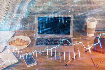 Multi exposure of graph and financial info and work space with computer background. Concept of...