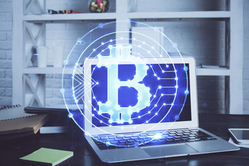 Multi exposure of blockchain theme hologram and table with computer background. Concept of bitcoin...