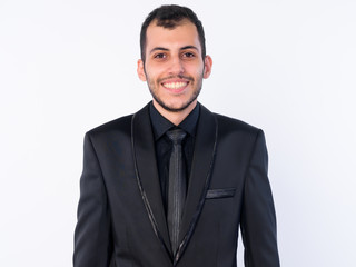 Face of happy young bearded Persian businessman in suit smiling