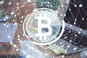 Multi exposure of blockchain theme hologram and table with computer background. Concept of bitcoin crypto currency.
