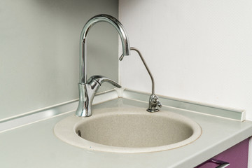 The photo of a sink in a The photo of a sink in a  kitchen