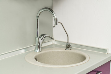 The photo of a sink in a The photo of a sink in a  kitchen