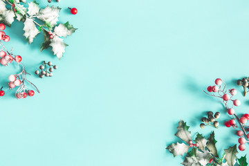 Christmas composition. Frame made of christmas plants on blue background. Flat lay, top view, copy space