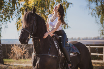 Rider elegant woman talking to her horse. Portrait of riding horse with woman . Equestrian horse...