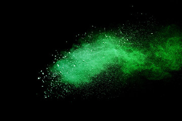 Green powder explosion on black background.