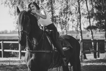 Rider elegant woman talking to her horse. Portrait of riding horse with woman . Equestrian horse...