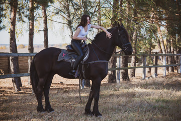 Rider elegant woman talking to her horse. Portrait of riding horse with woman . Equestrian horse with rider at nature 