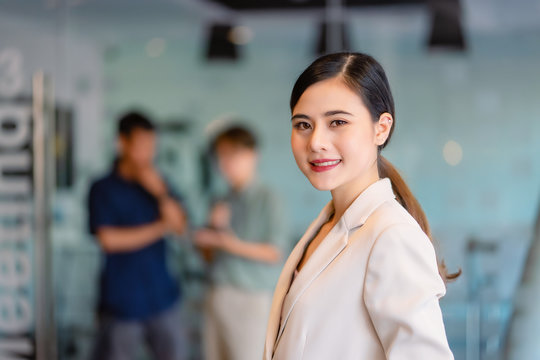 Young Asian happy woman stand in an office