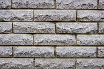 Close-up of grey brick wall texture background.
