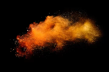 Rolgordijnen Abstract orange powder explosion isolated on black background. © piyaphong