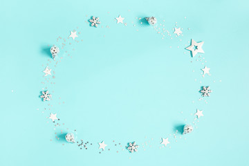 Christmas composition. Silver decorations on pastel blue background. Christmas, winter, new year concept. Flat lay, top view, copy space