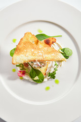 Crab napoleon with pike caviar sauce top view